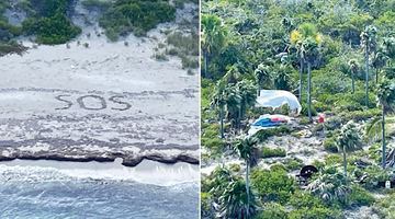 Зроблений на піску напис SOS побачили з гелікоптера. Як і «дім Робінзона»: той натягнув між пальмами вітрило зі затонулої яхти. Фото USCG